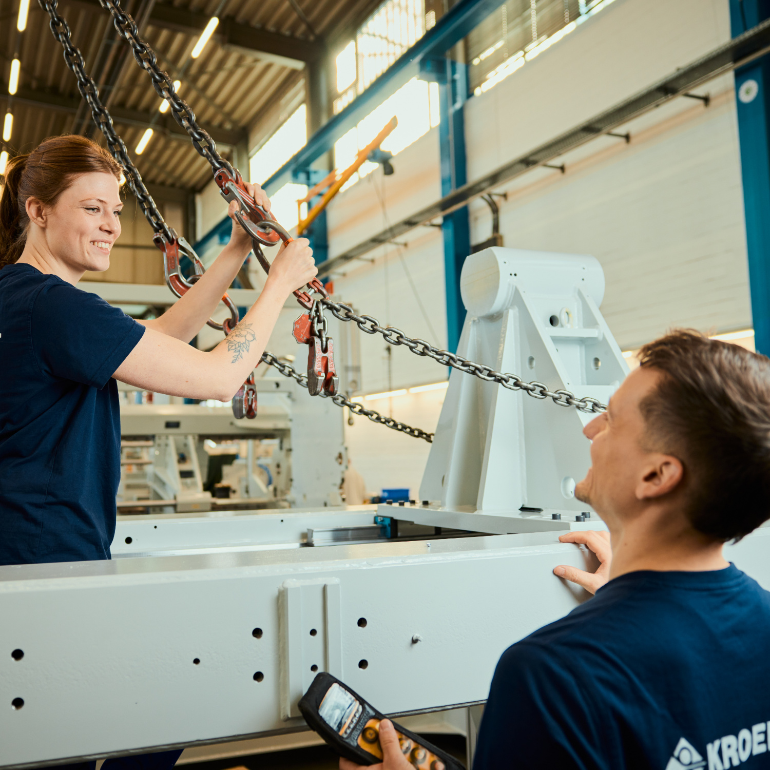 Careers at KROENERT demonstrated by two young people operating the crane.
